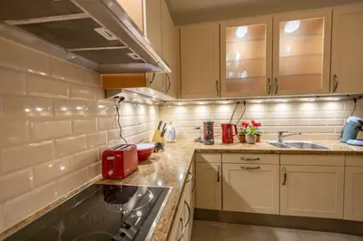 a kitchen with a sink and a red appliance at Зеления Осъм Green Osam in Chiflik