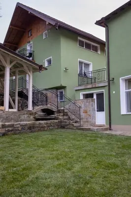 a green house with stairs and a grass yard at Зеления Осъм Green Osam in Chiflik