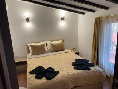 a bedroom with a bed with clothes on it at Villa Elias in Zlatograd