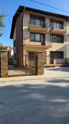 a building with a fence in front of it at Guest House Gogemi in Bansko