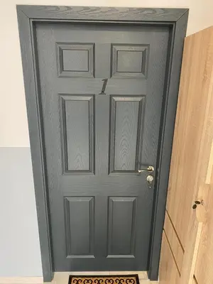 a gray door in a room next to a doorway at Apartments EMIZA in Samokov