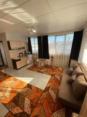 a living room with a couch and a table at Apartments EMIZA in Samokov