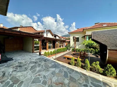 a backyard with a patio and a house at Къща за гости “Александър” in Velingrad