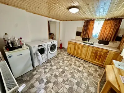 a kitchen with a washing machine and a washer at Къща за гости “Александър” in Velingrad