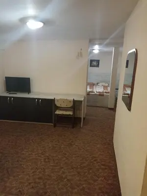 a room with a desk with a tv and a mirror at Petar Guest House in Bansko