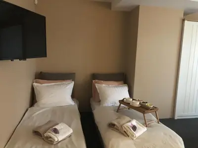 two beds sitting next to each other in a room at Lavender Suite in Dragichevo