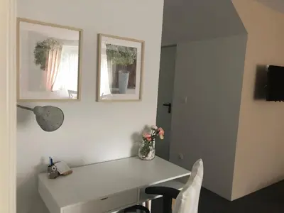 a room with a white desk with two pictures on the wall at Lavender Suite in Dragichevo