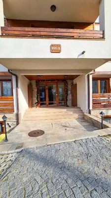 an entrance to a building with a sign on it at Apartmanica Double room apartment 101-12, with AC, big terrace, St Ivan Rilski 4 star SPA Resort, Bansko in Bansko