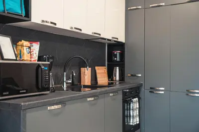 a kitchen with a sink and a microwave at Elite Business Residence with Free Gym Pass, Street Parking and Full Office Setup in Plovdiv