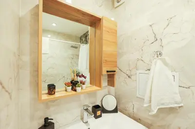 a bathroom with a sink and a mirror at Central Apartment near the Park in Gotse Delchev