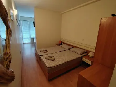 a bedroom with a bed with two shoes on it at Studio apartment with mountain view at Eagle Rock complex in Beli Iskar