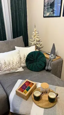 a living room with a couch with a christmas tree at The Green apartment in Borovets