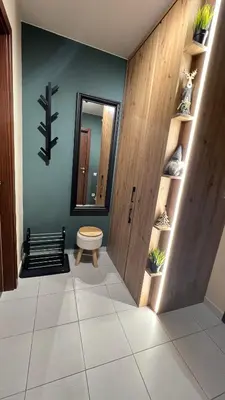 a hallway with a mirror and a bench in a room at The Green apartment in Borovets