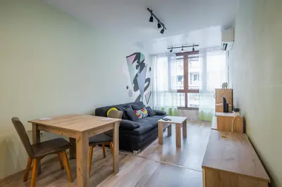 a living room with a couch and a table at Intelligent Elephant Home - 1BDR Apartment by Flat Mаnager in Sofia