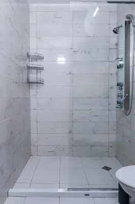 a white bathroom with a shower and a sink at Intelligent Elephant Home - 1BDR Apartment by Flat Mаnager in Sofia