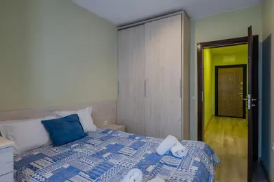 a bedroom with a bed with a blue and white comforter at Intelligent Elephant Home - 1BDR Apartment by Flat Mаnager in Sofia