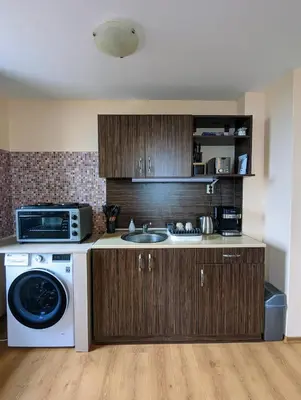 a kitchen with a sink and a washing machine at Stylish 2BD Apartment with Panoramic Mountain View by Flat Mаnager in Bansko