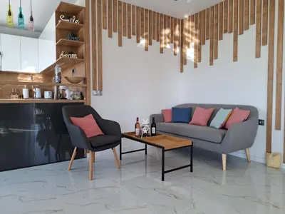 a living room with a couch and a table at Sunset view guest house in Ilindentsi