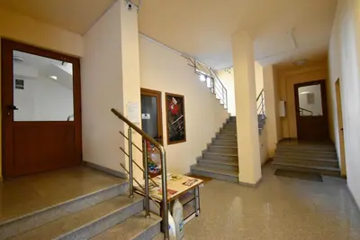 a hallway with stairs and a stair case at Panoramic Terrace City View Suite in Sofia Center in Sofia