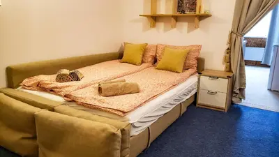 a bedroom with a large bed with yellow pillows at Apart 32 Govedartsi Forest View in Govedartsi