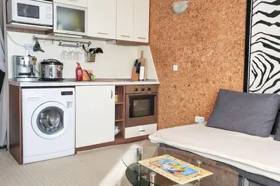 a kitchen with a washer and dryer in a room at Apart 32 Govedartsi Forest View in Govedartsi