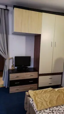 a bedroom with a bed and a dresser with a tv at Apart 32 Govedartsi Forest View in Govedartsi