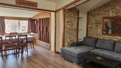 a living room with a couch and a table at Pirin Studios in Bansko