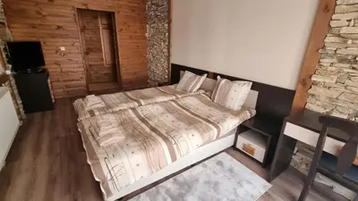 a bedroom with a large bed in a room at Pirin Studios in Bansko