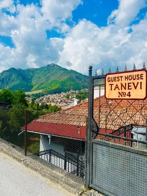 a sign on a fence next to a house at Guest House Tanevi in Devin