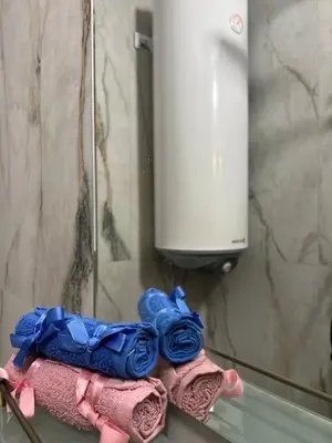 a pile of towels sitting on a shelf in a bathroom at Guest House Tanevi in Devin