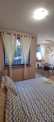 a bedroom with a bed and a table and a window at BoroHome in Borovets
