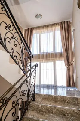 a staircase leading to a large window in a building at Hotel CITY Sandanski in Sandanski