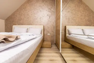 two beds in a small room with wooden floors at Sunny 1BD Apartment in OLD TOWN by Flat Mаnager in Plovdiv