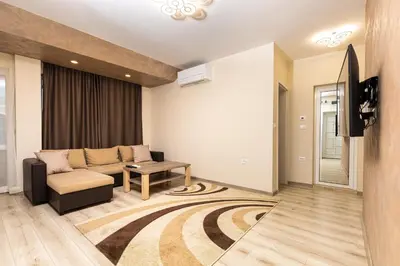 a living room with a couch and a tv at Sunny 1BD Apartment in OLD TOWN by Flat Mаnager in Plovdiv