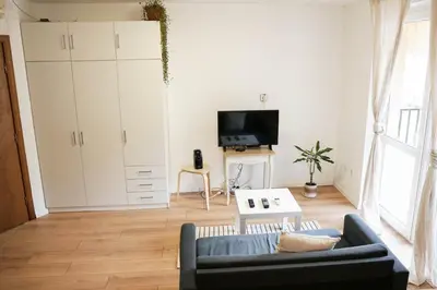 a living room with a couch and a tv at Stylish apartment, very good location! in Sofia
