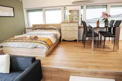 a bedroom with a bed and a table and chairs at Stylish apartment, very good location! in Sofia