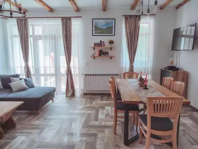 a living room with a table and a couch at Villa Tangra in Grashtitsa