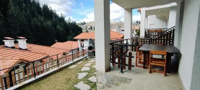 a balcony of a house with a view of the mountains at Villa Tangra in Grashtitsa