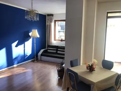 a living room with a table and a couch at One Bedroom Flat With Garden and Barbeque in Bansko