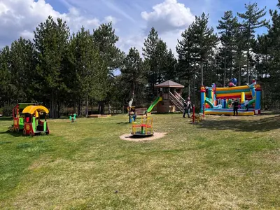 a park with several playground equipment in a field at Pirin Golf SPA Studio Mountain View Compass Property in Bansko