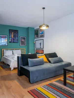 a living room with a couch and a bed at Modern&Stylish Studio in City Centre by Flat Mаnager in Sofia