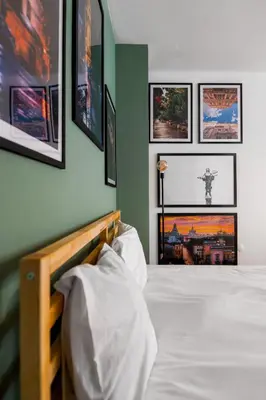 a bedroom with a bed with pictures on the wall at Modern&Stylish Studio in City Centre by Flat Mаnager in Sofia