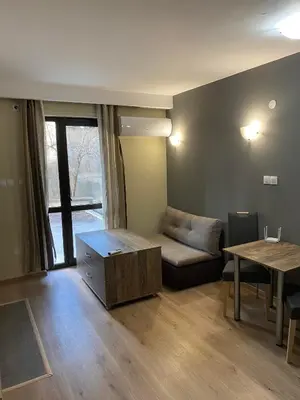 a living room with a couch and a table at Grand Apartments in Bansko