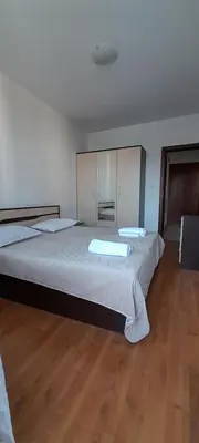 a bedroom with two beds and a wooden floor at Belvedere Holiday Club К302 in Bansko