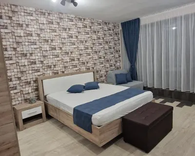 a bedroom with a bed and a brick wall at B55 Studio in Borovets