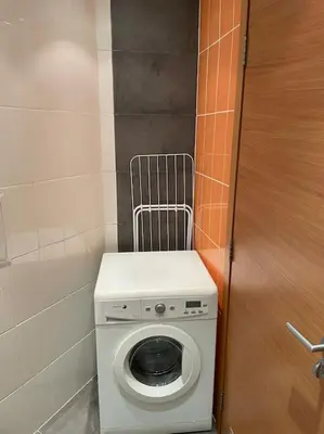 a washing machine in a bathroom with a door at SliverCity next to paradise mall in Sofia