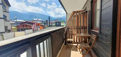 a balcony with a bench and a view of a city at Gondola Ski Lift Apartment in Bansko
