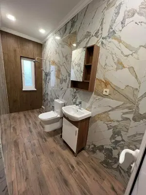a bathroom with a white toilet and a sink at Elegant and cozy room ARAKS in Kostinbrod