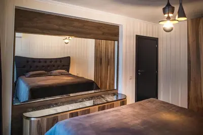 a bedroom with a large mirror and a bed at Lux Apart Karlovo in Karlovo