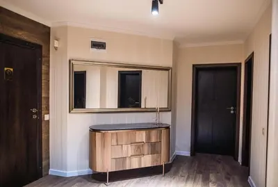 a bathroom with a wooden vanity and a mirror at Lux Apart Karlovo in Karlovo